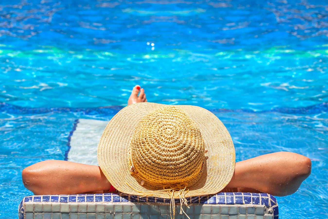 woman relaxing by pool at Lexington I & II apartments