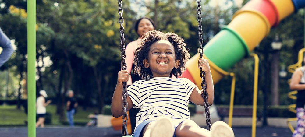 little kid playing in playground AMENITIES  at Lexington I & II Apartments, Lexington Apartments, apartments near me, apartments in Atlanta, Atlanta GA apartments, townhouses in Atlanta, townhouse to rent in ATL